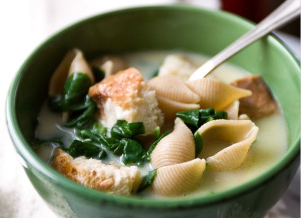 A bowl of food on a plate Description automatically generated